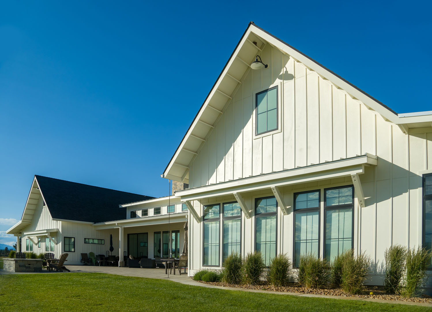 Large white farmhouse with numerous windows to view green farmland