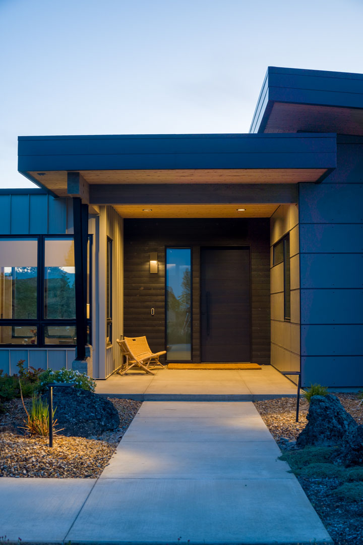 Evening view of new custom build for a home in Deschutes County by Full Circle Design